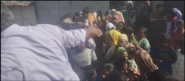 Waste picker families receiving ration kits at community distribution drive in Delhi