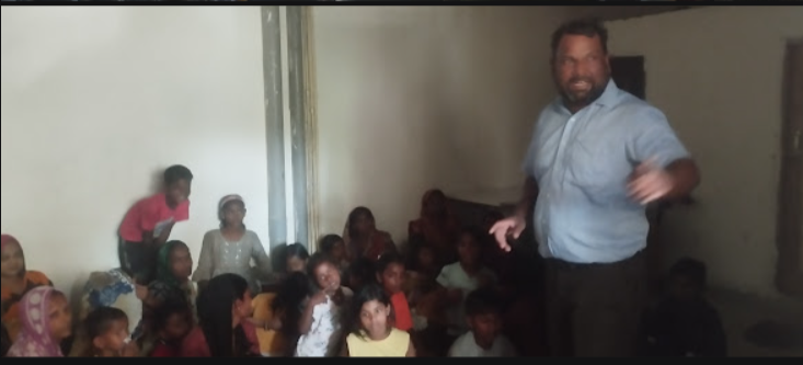 NGO worker speaking to waste picker children about education and hygiene